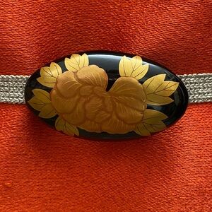 Obidome-Camelia flower with gold colored leaves on black